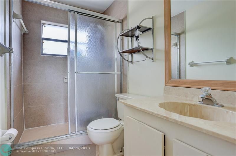 9649 Northwest 4th Street, Unit 5E Coral Springs, FL 33071 - Photo 12 of 30 a bathroom with a sink toilet and shower