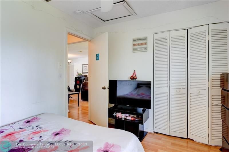 9649 Northwest 4th Street, Unit 5E Coral Springs, FL 33071 - Photo 14 of 30 a bedroom with a bed window and a flat screen tv