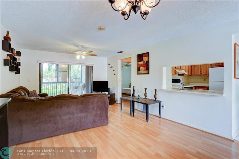 9649 Northwest 4th Street, Unit 5E Coral Springs, FL 33071 - Photo 3 of 30 a living room with furniture and a flat screen tv