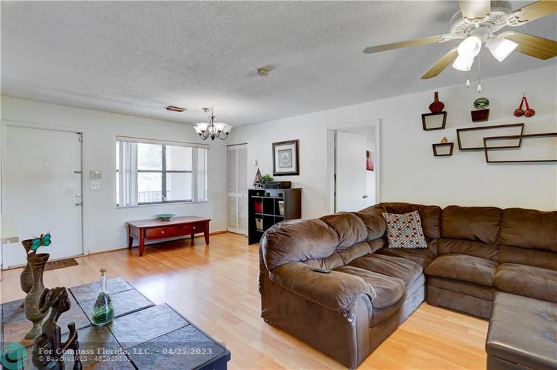 9649 Northwest 4th Street, Unit 5E Coral Springs, FL 33071 - Photo 5 of 30 a living room with furniture and wooden floor