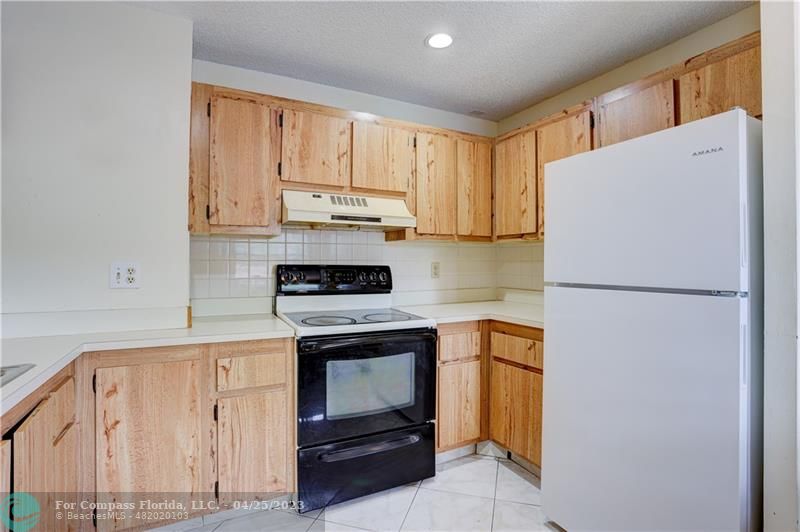 9649 Northwest 4th Street, Unit 5E Coral Springs, FL 33071 - Photo 8 of 30 a kitchen with stainless steel appliances a refrigerator sink and cabinets
