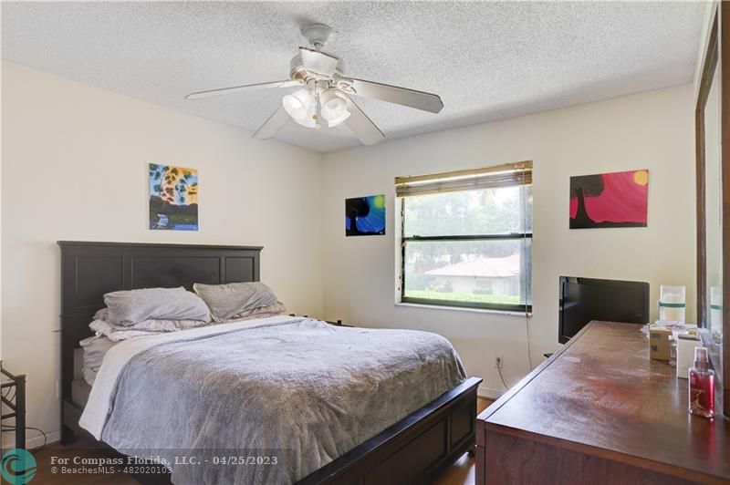 9649 Northwest 4th Street, Unit 5E Coral Springs, FL 33071 - Photo 9 of 30 a bedroom with a large bed and a window