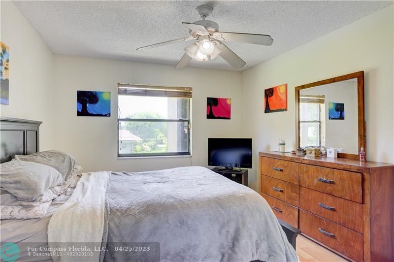 9649 Northwest 4th Street, Unit 5E Coral Springs, FL 33071 - Photo 10 of 30 a bedroom with a bed and a fireplace