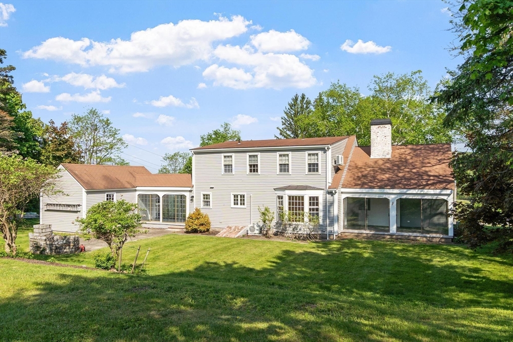 454 Wilson Street Clinton, MA 01510 - Photo 9 of 39 a view of a white house with a big yard and potted plants