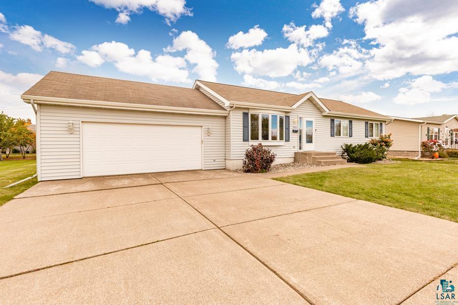 2020 East 11th Street Superior, WI 54880 - Photo 1 of 30 Ranch-style home with a front lawn, concrete driveway, and an attached garage