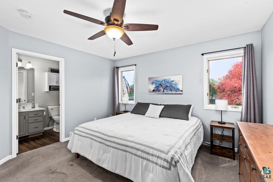 2020 East 11th Street Superior, WI 54880 - Photo 13 of 30 Bedroom with dark carpet, ensuite bathroom, and ceiling fan