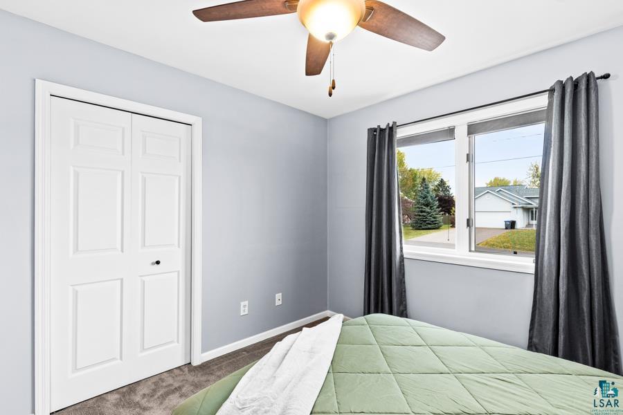 2020 East 11th Street Superior, WI 54880 - Photo 18 of 30 Bedroom with dark carpet, ceiling fan, and a closet