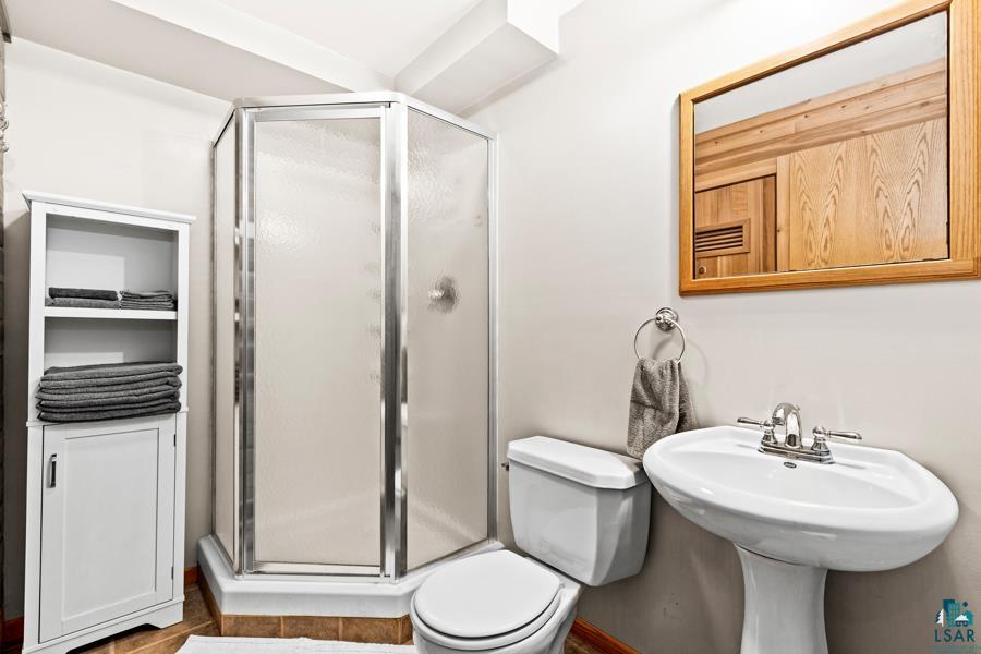 2020 East 11th Street Superior, WI 54880 - Photo 23 of 30 Bathroom featuring toilet and a shower stall