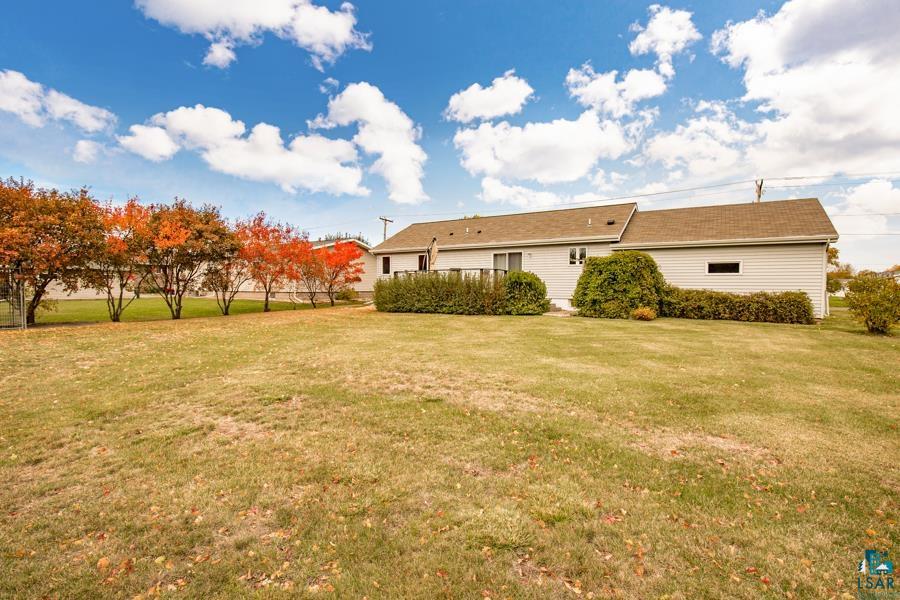 2020 East 11th Street Superior, WI 54880 - Photo 3 of 30 Rear view of house featuring a lawn
