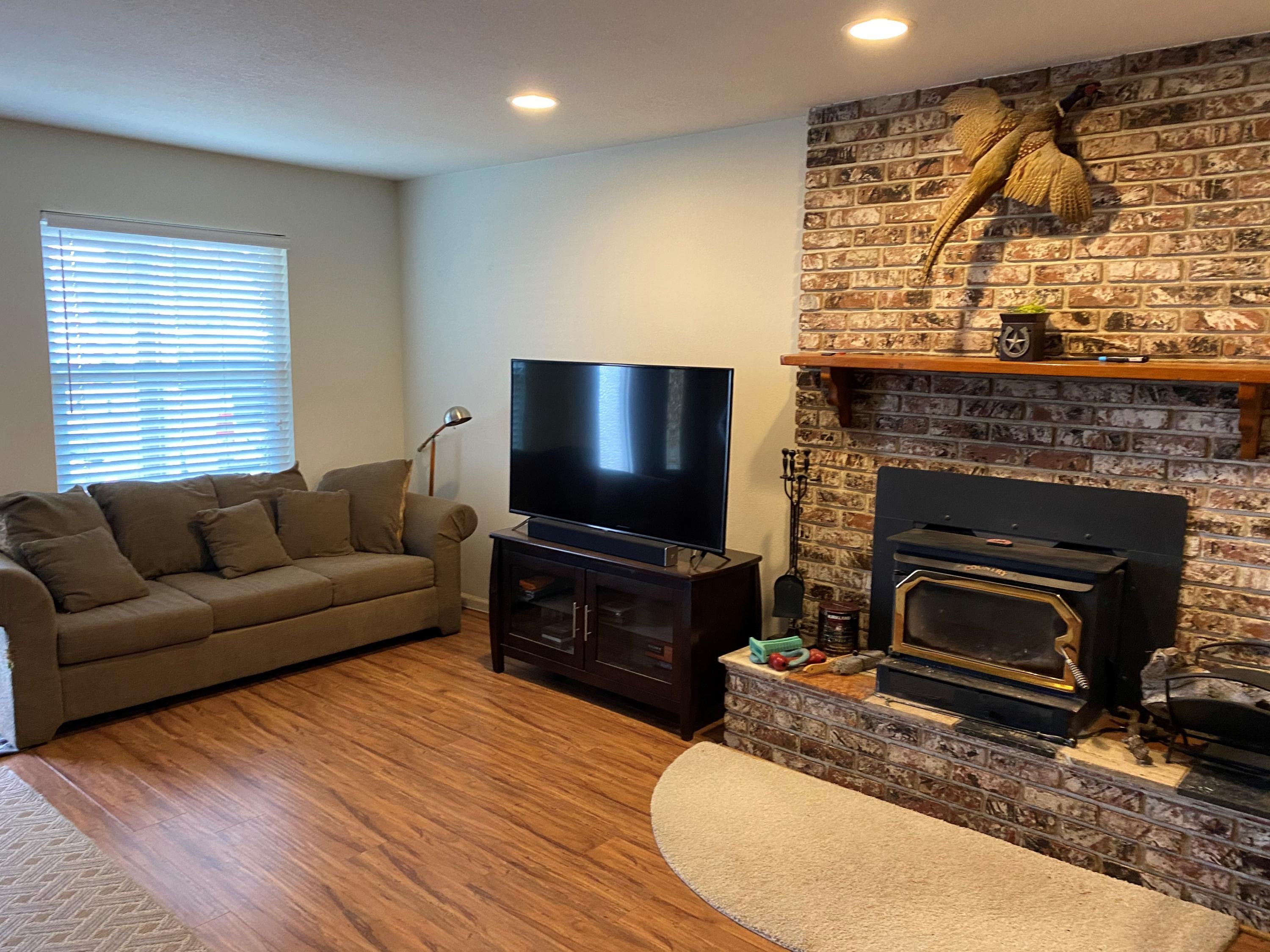 351 South Cornucopia Road Exeter, CA 93221 - Photo 6 of 22 a living room with furniture a flat screen tv and a fireplace