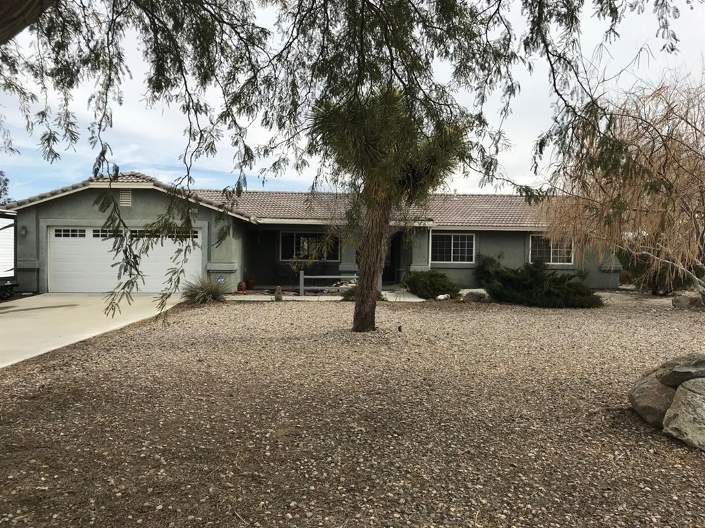 11459 Daisy Road Victorville, CA 92392 - Photo 1 of 1 a front view of a house with garden