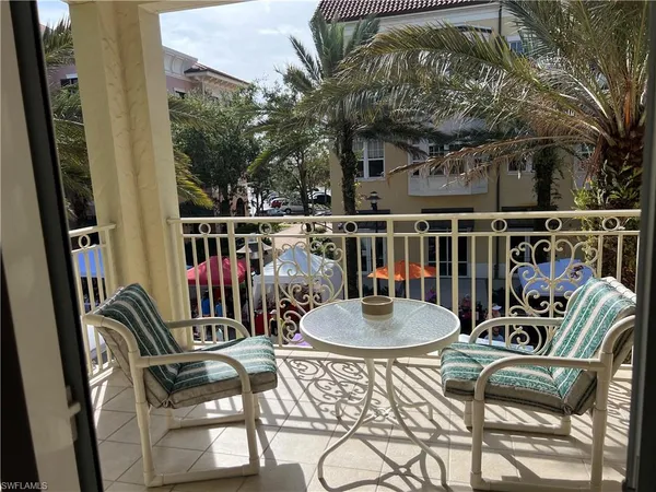 a balcony with table and chairs