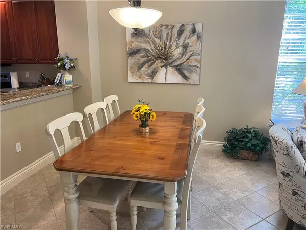 a dining room with furniture and wooden floor