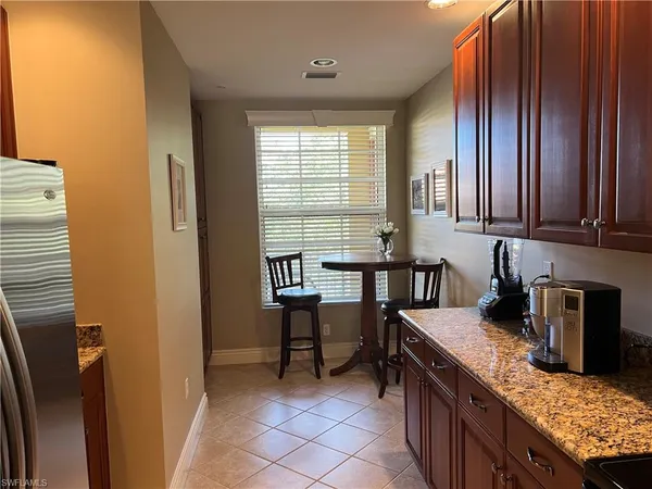 a kitchen with granite countertop a sink and a stove