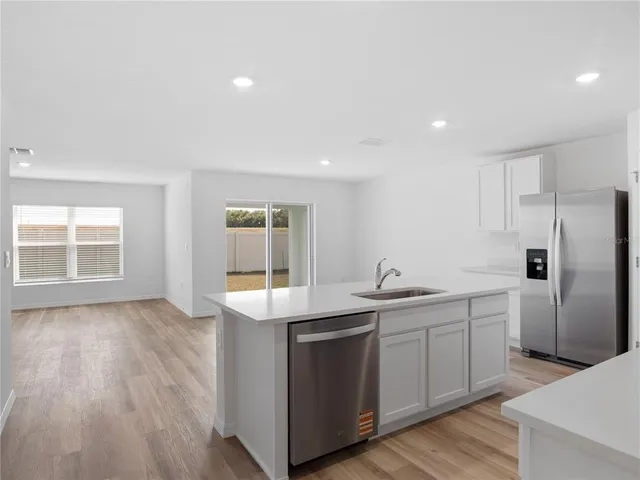 a kitchen with a sink and wooden cabinets