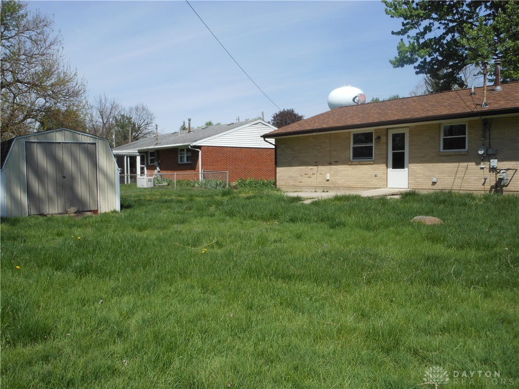 143 West Emerick Road West Milton, OH 45383 - Photo 26 of 37 This spacious backyard features a versatile shed and a charming brick exterior.