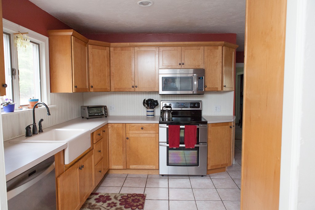 235 Ellis Road Westminster, MA 01473 - Photo 5 of 30 a kitchen with stainless steel appliances a sink a stove a microwave cabinets and a window
