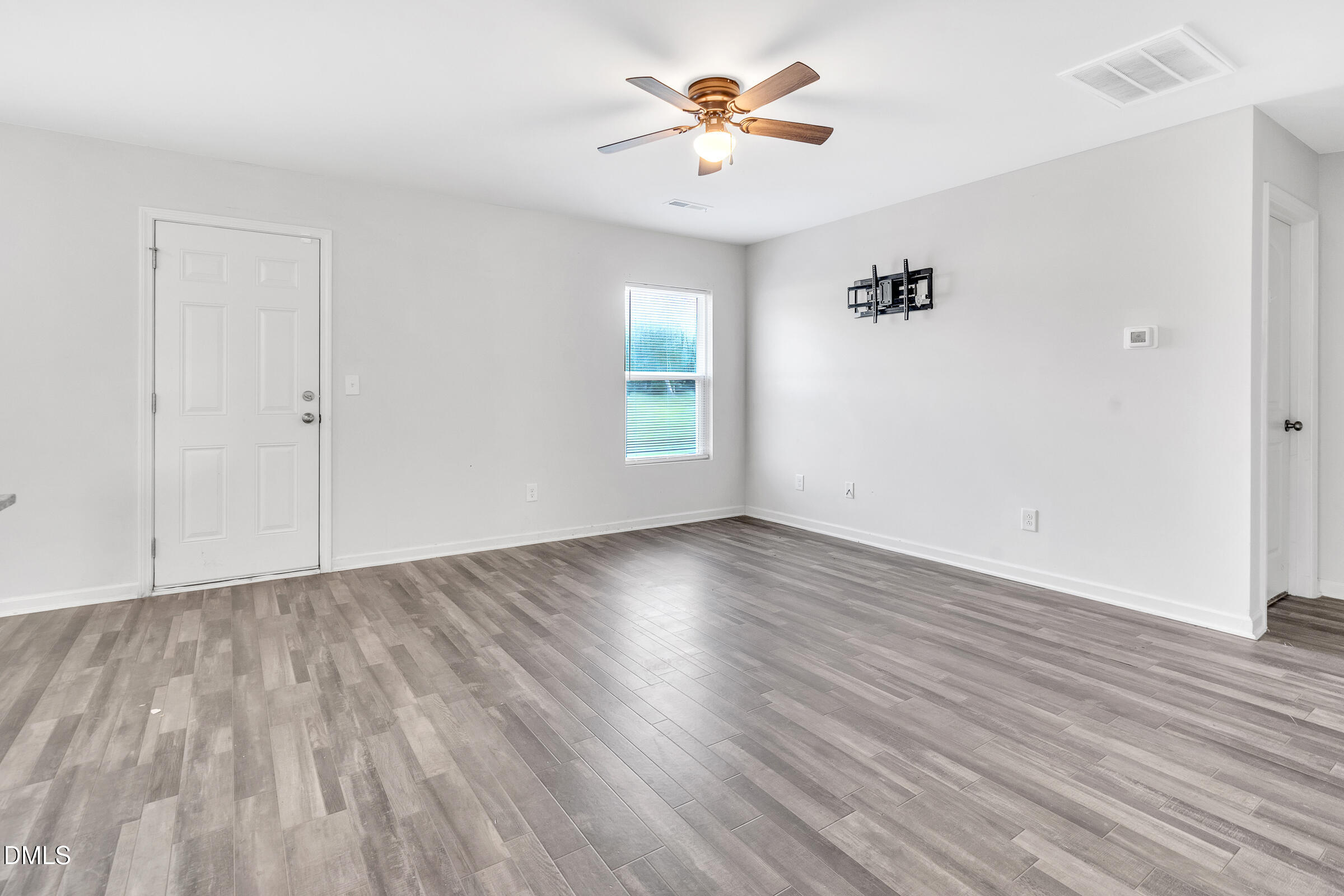 3146 Stoney Hill Church Road Bailey, NC 27807 - Photo 8 of 26 an empty room with wooden floor and windows