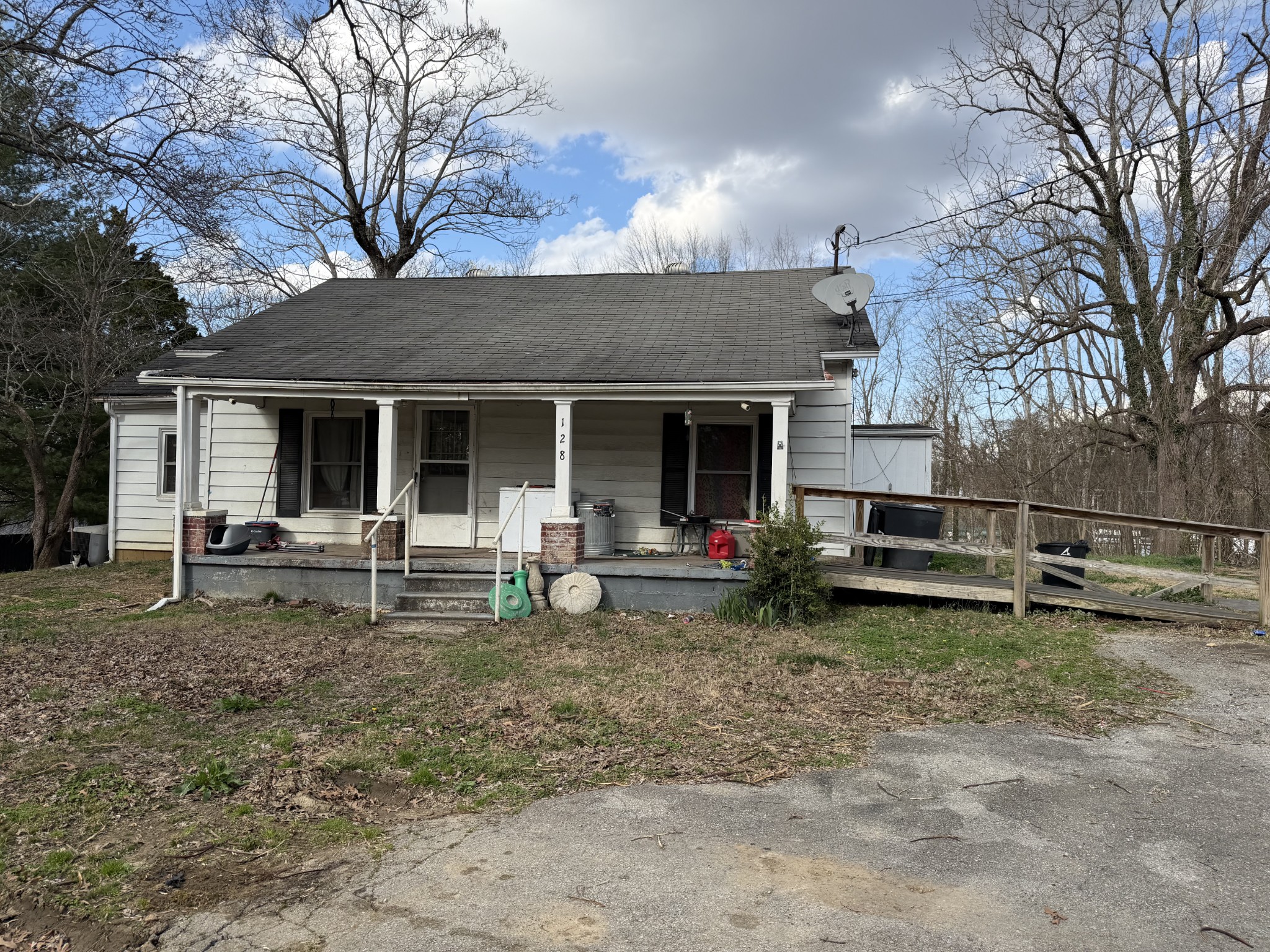 a view of a house with a yard and sitting area
