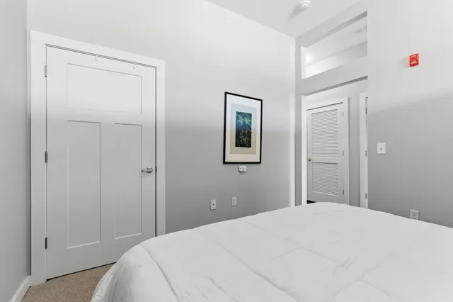 a bedroom with a bed and closet