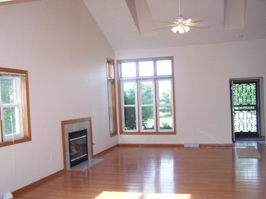 2380 Gustafson Road Belvidere, IL 61008 - Photo 2 of 11 a view of an empty room with a window and wooden floor