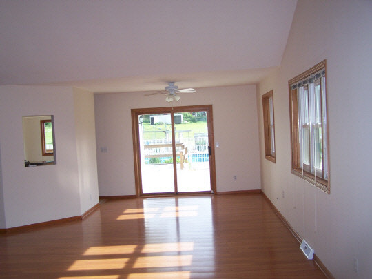 2380 Gustafson Road Belvidere, IL 61008 - Photo 3 of 11 a view of an empty room with wooden floor and a window