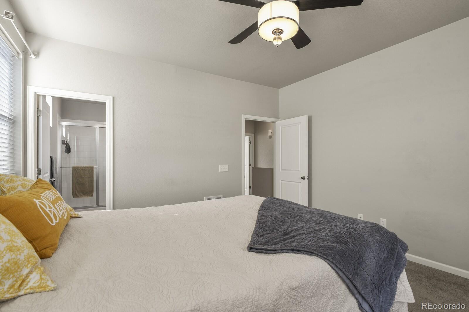 1078 Oak Circle Denver, CO 80215 - Photo 15 of 29 a bedroom with a large bed and chandelier