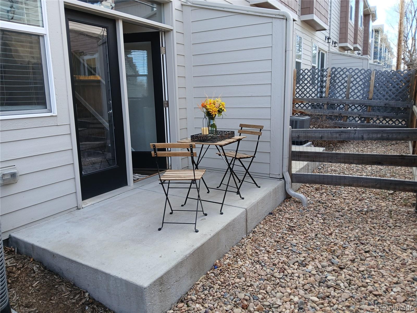 1078 Oak Circle Denver, CO 80215 - Photo 21 of 29 a view of a patio with table and chairs and wooden floor