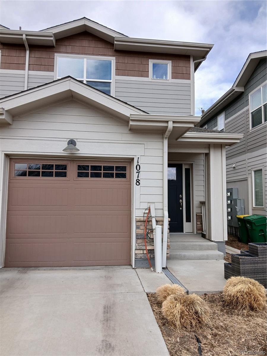 1078 Oak Circle Denver, CO 80215 - Photo 4 of 29 a front view of a house with garage