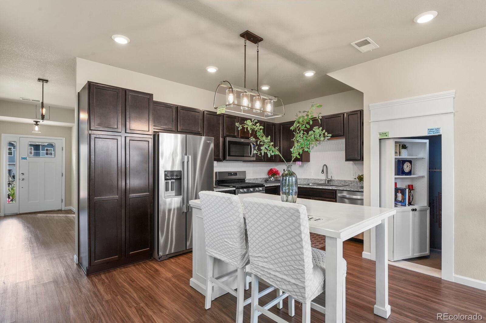 1078 Oak Circle Denver, CO 80215 - Photo 6 of 29 a kitchen with stainless steel appliances a refrigerator sink and microwave