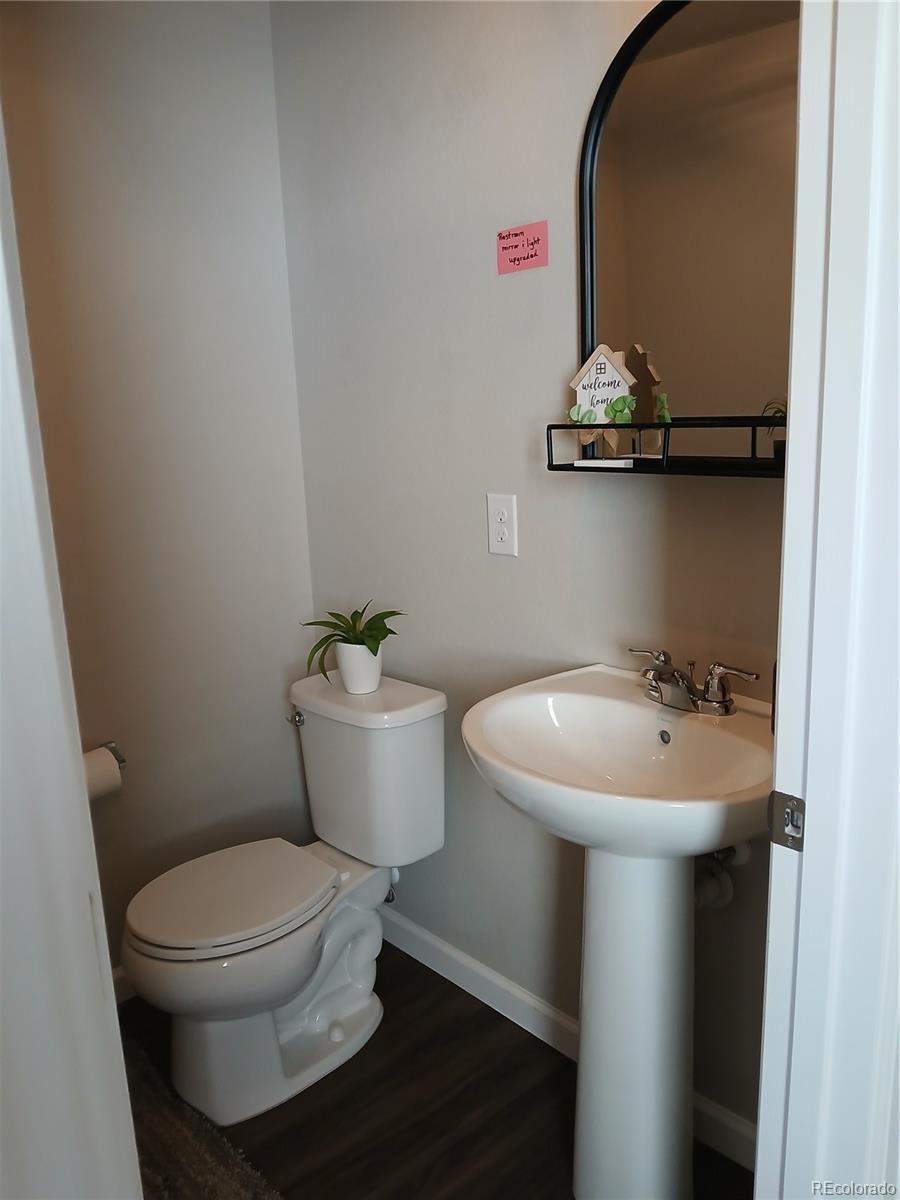 1078 Oak Circle Denver, CO 80215 - Photo 7 of 29 a bathroom with a toilet a sink and wooden floor