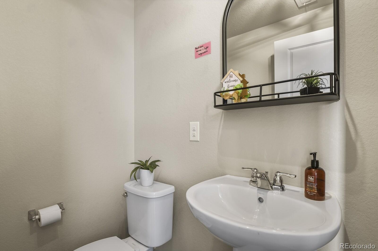 1078 Oak Circle Denver, CO 80215 - Photo 8 of 29 a bathroom with a sink and mirror with toilet