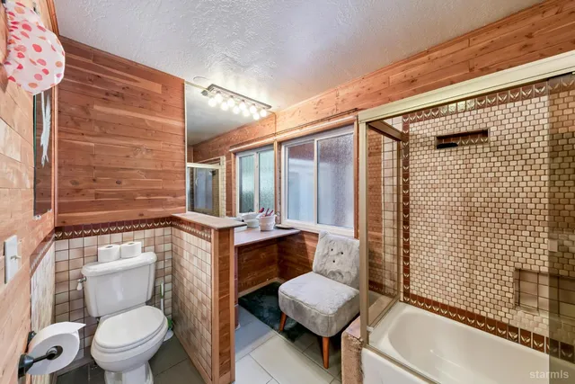a bathroom with a toilet a sink and shower