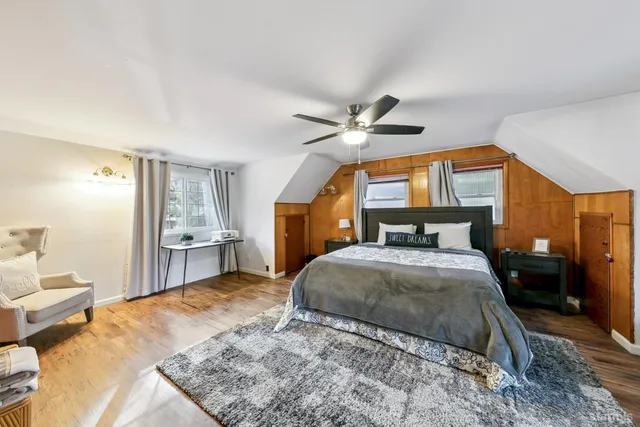 a bedroom with a bed and a chandelier