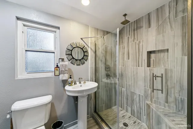 a bathroom with a sink toilet and shower