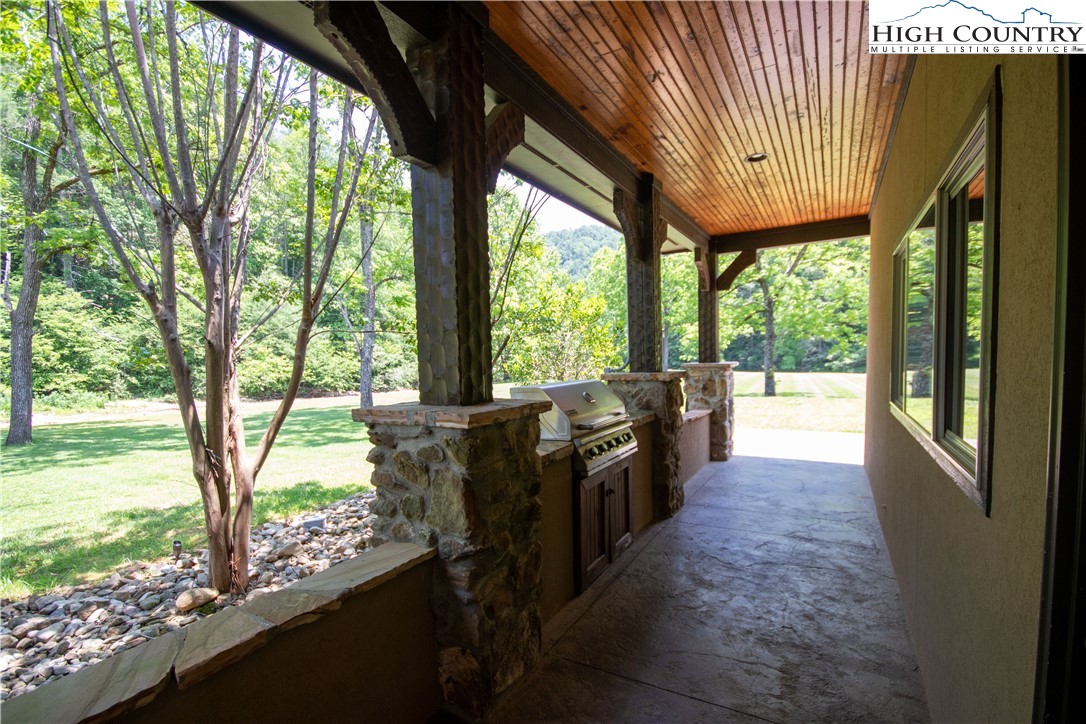 Lot#547 Autumn Ridge Drive Lenoir, NC 28645 - Photo 46 of 50 a view of a porch with wooden floor and furniture