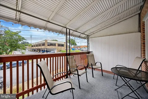 a view of a two chairs in the balcony