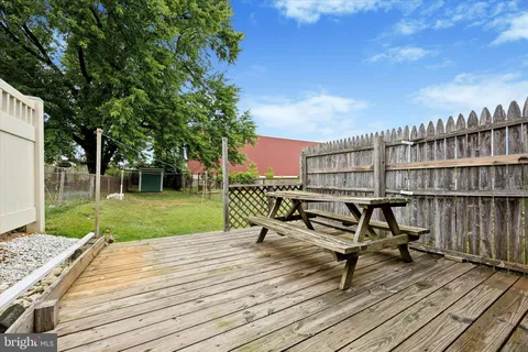 a park view with a bench and wooden floor