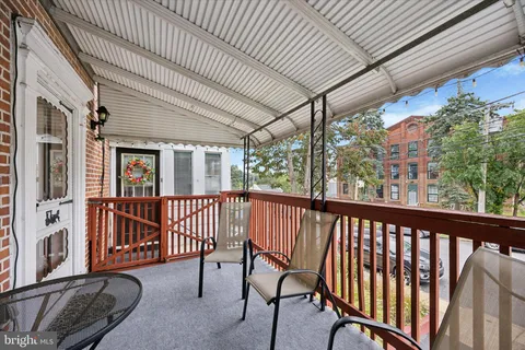 a view of a chairs and table in the balcony