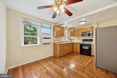 a kitchen with a refrigerator a stove and a microwave