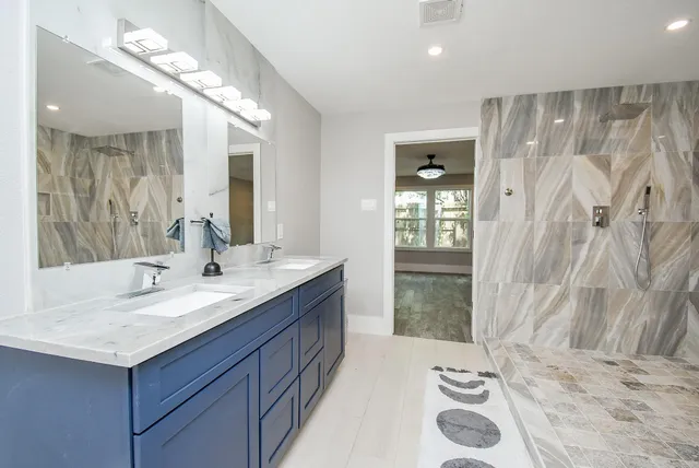 a bathroom with a sink double vanity and a mirror