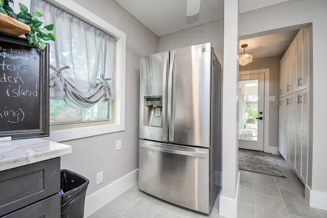 a view of kitchen with stainless steel appliances granite countertop a refrigerator and a sink