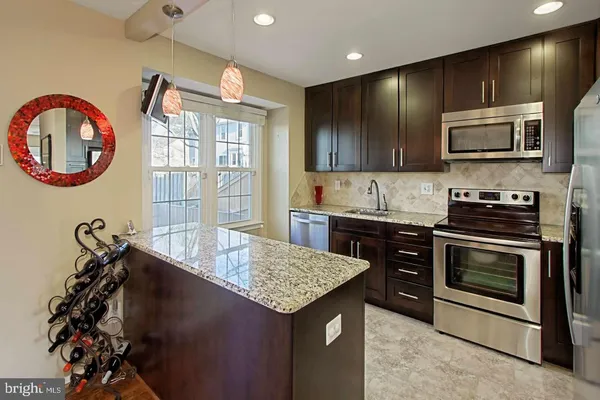 a kitchen with a stove a sink and a microwave