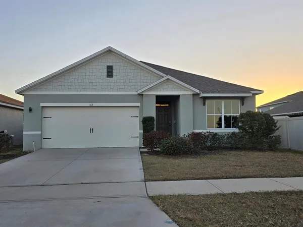 a front view of a house with garage