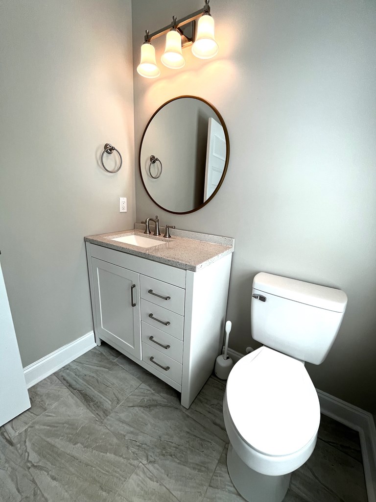 4024 Valley Road Columbus, GA 31907 - Photo 11 of 35 a bathroom with a toilet mirror vanity and a sink