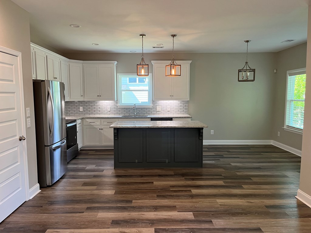 4024 Valley Road Columbus, GA 31907 - Photo 13 of 35 a kitchen with stainless steel appliances granite countertop a refrigerator a stove and a wooden floors