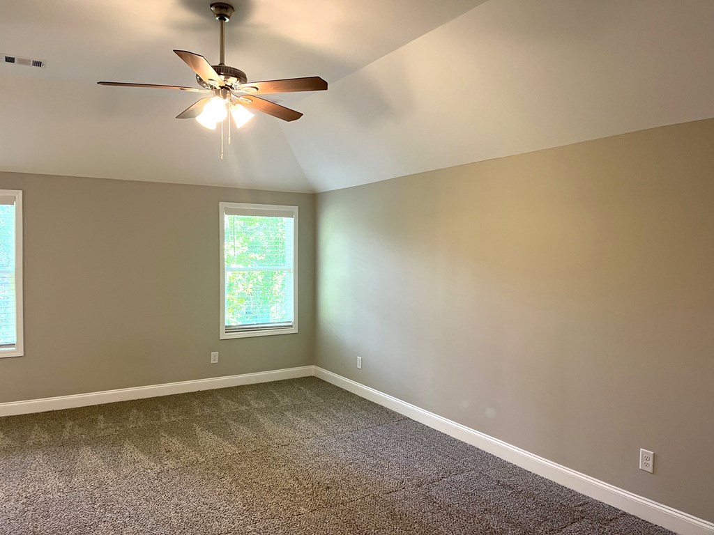 4024 Valley Road Columbus, GA 31907 - Photo 24 of 35 an empty room with a window and a chandelier fan