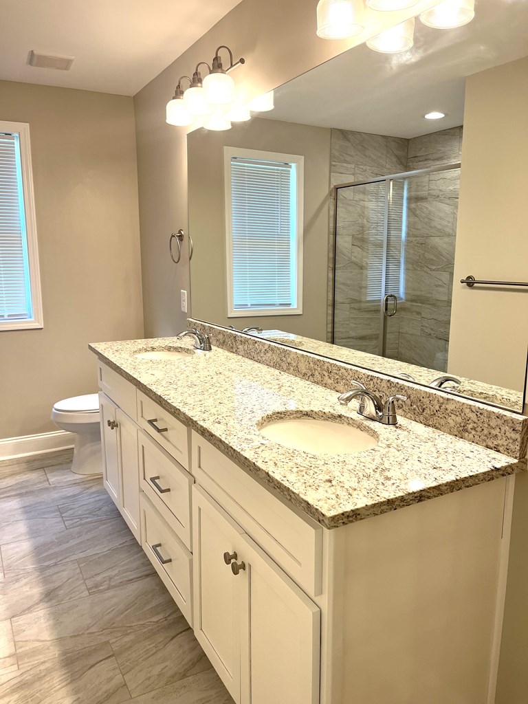 4024 Valley Road Columbus, GA 31907 - Photo 27 of 35 a bathroom with a granite countertop sink and a mirror
