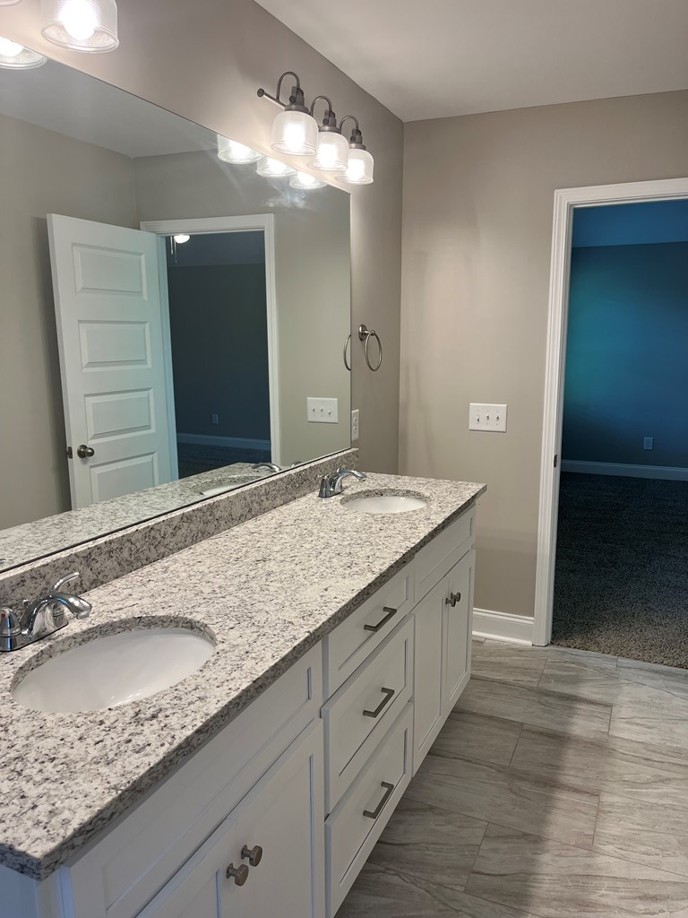 4024 Valley Road Columbus, GA 31907 - Photo 28 of 35 a bathroom with a granite countertop double vanity sink and a mirror
