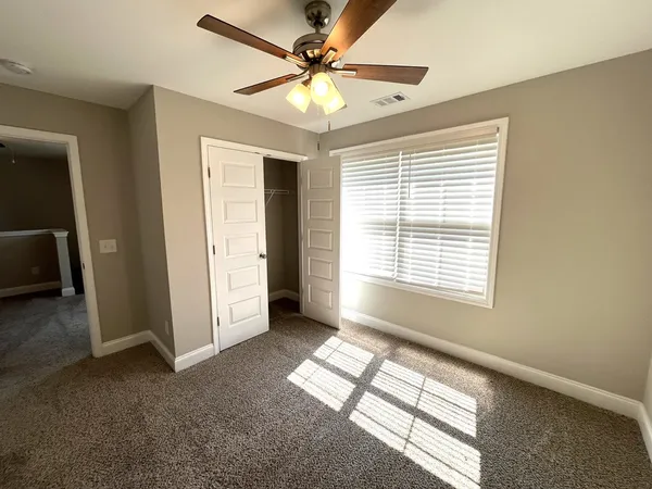 a view of livingroom with window and a ceiling fan